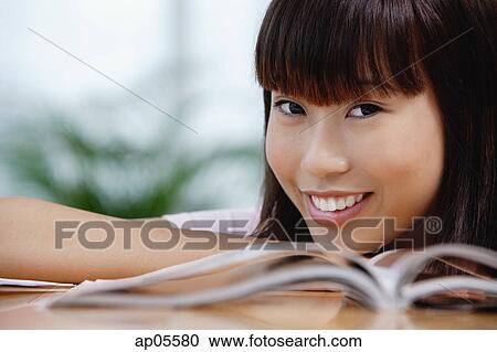 Young woman smiling at camera View Large Photo Image Stock Image - Young woman smiling at camera. Fotosearch