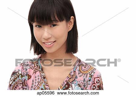Stock Photograph - Young woman smiling at camera. Fotosearch