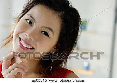 Young woman smiling, head shot View Large Photo Image Stock Photography - Young woman smiling, head shot. Fotosearch