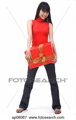 Young woman standing with big red gift box View Large Photo Image Stock Photo - Young woman standing with big red gift box. Fotosearch