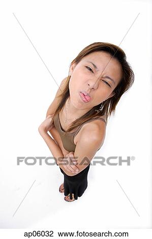 Young woman sticking out her tongue, making a face View Large Photo Image Stock Image - Young woman sticking out her tongue, making a face. Fotosearch