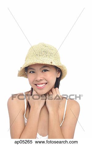 Stock Photography - Young woman wearing hat, smiling. Fotosearch