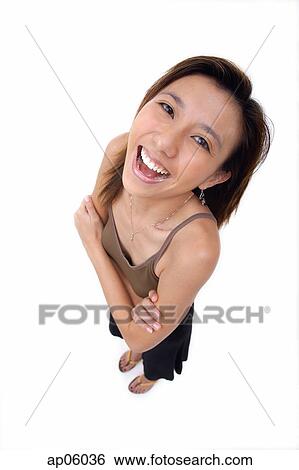 Young woman with arms crossed, smiling up at camera View Large Photo Image Stock Photograph - Young woman with arms crossed, smiling up at camera. Fotosearch