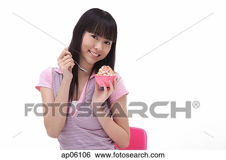 Stock Photograph - Young woman with bowl of ice cream. Fotosearch