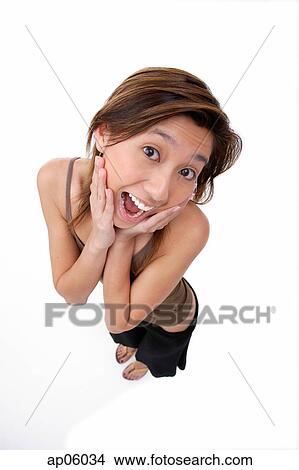 Young woman with hands on either side of her face View Large Photo Image Picture - Young woman with hands on either side of her face. Fotosearch