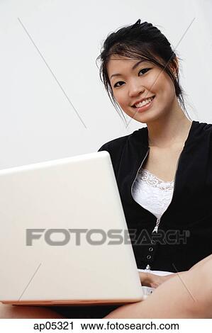 Young woman with laptop, looking at camera View Large Photo Image Stock Image - Young woman with laptop, looking at camera. Fotosearch