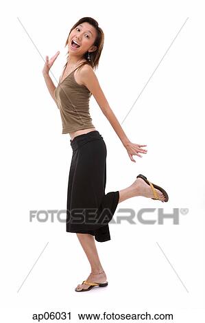 Young woman with mouth open, standing on one leg View Large Photo Image Stock Image - Young woman with mouth open, standing on one leg. Fotosearch