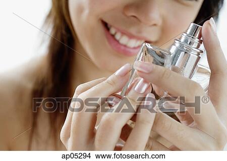 Young woman with perfume bottle View Large Photo Image Picture - Young woman with perfume bottle. Fotosearch