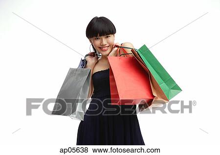Young woman with shopping bags View Large Photo Image Stock Photo - Young woman with shopping bags. Fotosearch