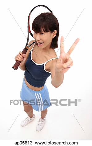 Young woman with tennis racket, looking up at camera, making hand sign View Large Photo Image Stock Image - Young woman with tennis racket, looking up at camera, making hand sign. Fotosearch