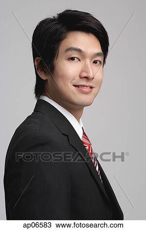 Businessman looking at camera, head shot View Large Photo Image Stock Image - Businessman looking at camera, head shot. Fotosearch