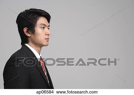 Picture - Businessman looking away, studio shot. Fotosearch