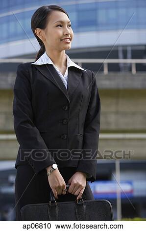 Businesswoman with briefcase, looking away View Large Photo Image Stock Image - Businesswoman with briefcase, looking away. Fotosearch
