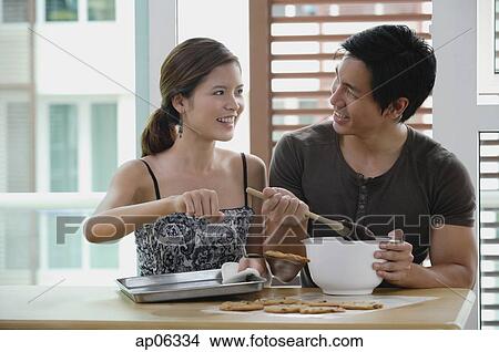 Picture - Couple in kitchen, making cookies. Fotosearch