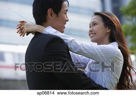 Couple looking at each other, embracing View Large Photo Image Picture - Couple looking at each other, embracing. Fotosearch