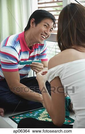 Couple playing scrabble, over the shoulder view View Large Photo Image Picture - Couple playing scrabble, over the shoulder view. Fotosearch