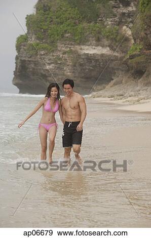 Couple walking on beach View Large Photo Image Stock Photo - Couple walking on beach. Fotosearch
