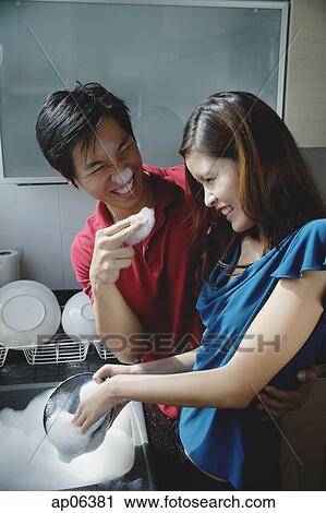 Couple washing dishes, playing with soap suds View Large Photo Image Stock Image - Couple washing dishes, playing with soap suds. Fotosearch
