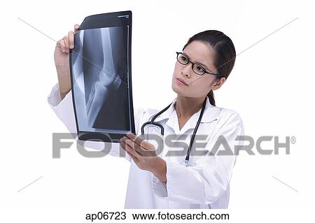 Doctor studying X-ray View Large Photo Image Stock Image - Doctor studying X-ray. Fotosearch