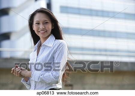 Female executive smiling at camera, hands clasped View Large Photo Image Stock Image - Female executive smiling at camera, hands clasped. Fotosearch
