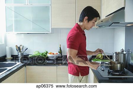 Man cooking in kitchen View Large Photo Image Stock Photography - Man cooking in kitchen. Fotosearch