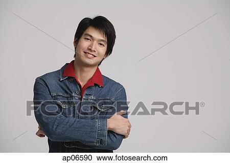 Man in denim jacket, arms crossed View Large Photo Image Stock Image - Man in denim jacket, arms crossed. Fotosearch
