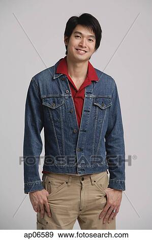 Stock Photo - Man in denim jacket, looking at camera. Fotosearch