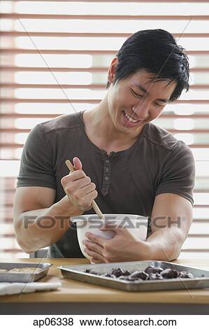 Man in kitchen stirring dough in mixing bowl View Large Photo Image Stock Photo - Man in kitchen stirring dough in mixing bowl. Fotosearch