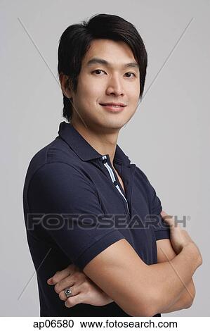 Man in polo shirt, looking at camera View Large Photo Image Stock Image - Man in polo shirt, looking at camera. Fotosearch