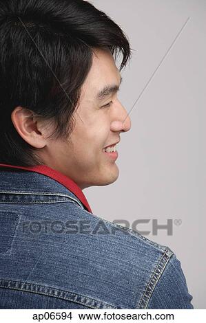 Picture - Man smiling, over the shoulder view. Fotosearch