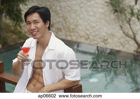 Man with cocktail in hand, portrait View Large Photo Image Stock Image - Man with cocktail in hand, portrait. Fotosearch