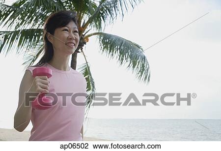 Mature woman using dumbbell outdoors View Large Photo Image Stock Image - Mature woman using dumbbell outdoors. Fotosearch