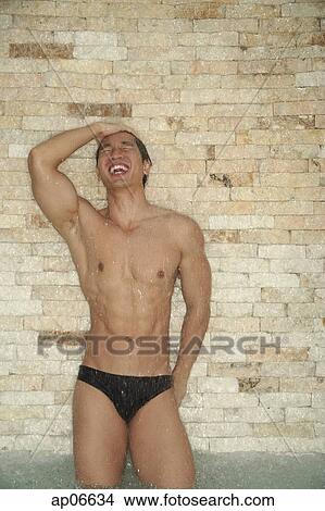 Muscular man showering, eyes closed View Large Photo Image Picture - Muscular man showering, eyes closed. Fotosearch