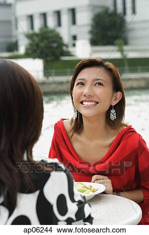 Picture - Two women at sidewalk cafe. Fotosearch