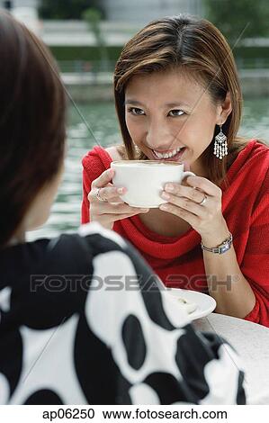 Two women having coffee View Large Photo Image Stock Image - Two women having coffee. Fotosearch