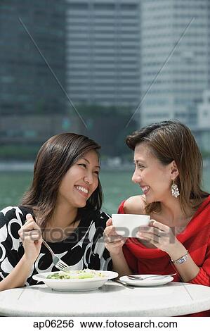 Two women having lunch View Large Photo Image Stock Photograph - Two women having lunch. Fotosearch