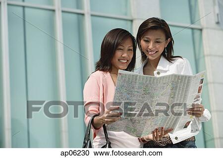Stock Image - Two women looking at map. Fotosearch