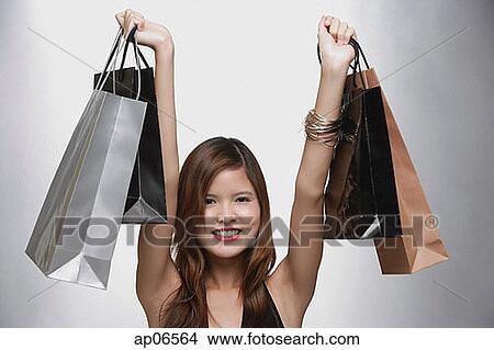 Woman carrying shopping bags View Large Photo Image Picture - Woman carrying shopping bags. Fotosearch