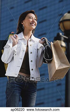 Woman carrying shopping bags View Large Photo Image Stock Image - Woman carrying shopping bags. Fotosearch