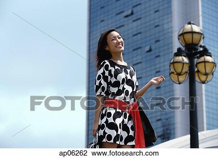 Stock Image - Woman carrying shopping bags. Fotosearch
