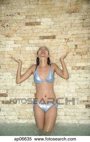 Woman in bikini taking a shower View Large Photo Image Stock Photography - Woman in bikini taking a shower. Fotosearch