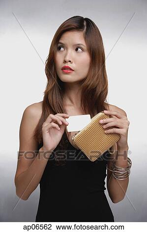 Woman in black top, putting credit card into purse View Large Photo Image Stock Image - Woman in black top, putting credit card into purse. Fotosearch