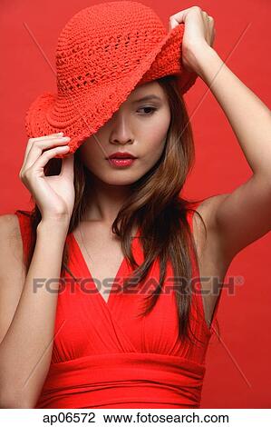 Woman in red dress with red hat View Large Photo Image Stock Image - Woman in red dress with red hat. Fotosearch