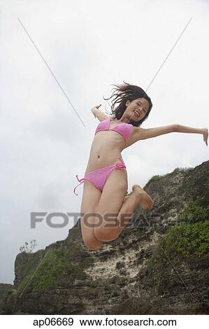 Woman jumping in air View Large Photo Image Stock Photo - Woman jumping in air. Fotosearch