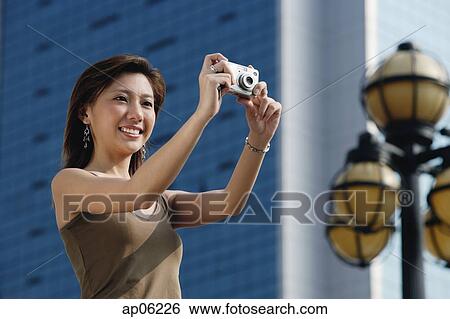 Woman taking a picture View Large Photo Image Stock Photograph - Woman taking a picture. Fotosearch