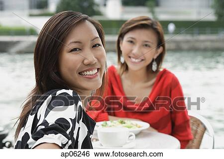 Women at sidewalk cafe, smiling at camera View Large Photo Image Stock Photograph - Women at sidewalk cafe, smiling at camera. Fotosearch