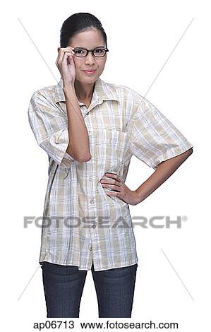 Young woman adjusting eyeglasses, hands on hip View Large Photo Image Stock Image - Young woman adjusting eyeglasses, hands on hip. Fotosearch