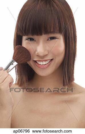 Young woman applying blusher View Large Photo Image Stock Photograph - Young woman applying blusher. Fotosearch