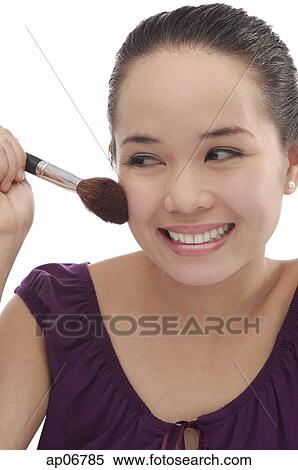 Young woman applying make-up View Large Photo Image Stock Photography - Young woman applying make-up. Fotosearch