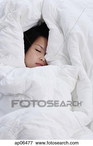 Young woman covered by blanket, sleeping View Large Photo Image Stock Photo - Young woman covered by blanket, sleeping. Fotosearch
